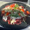 Carpaccio di filetto con funghi, sedano e parmigiano